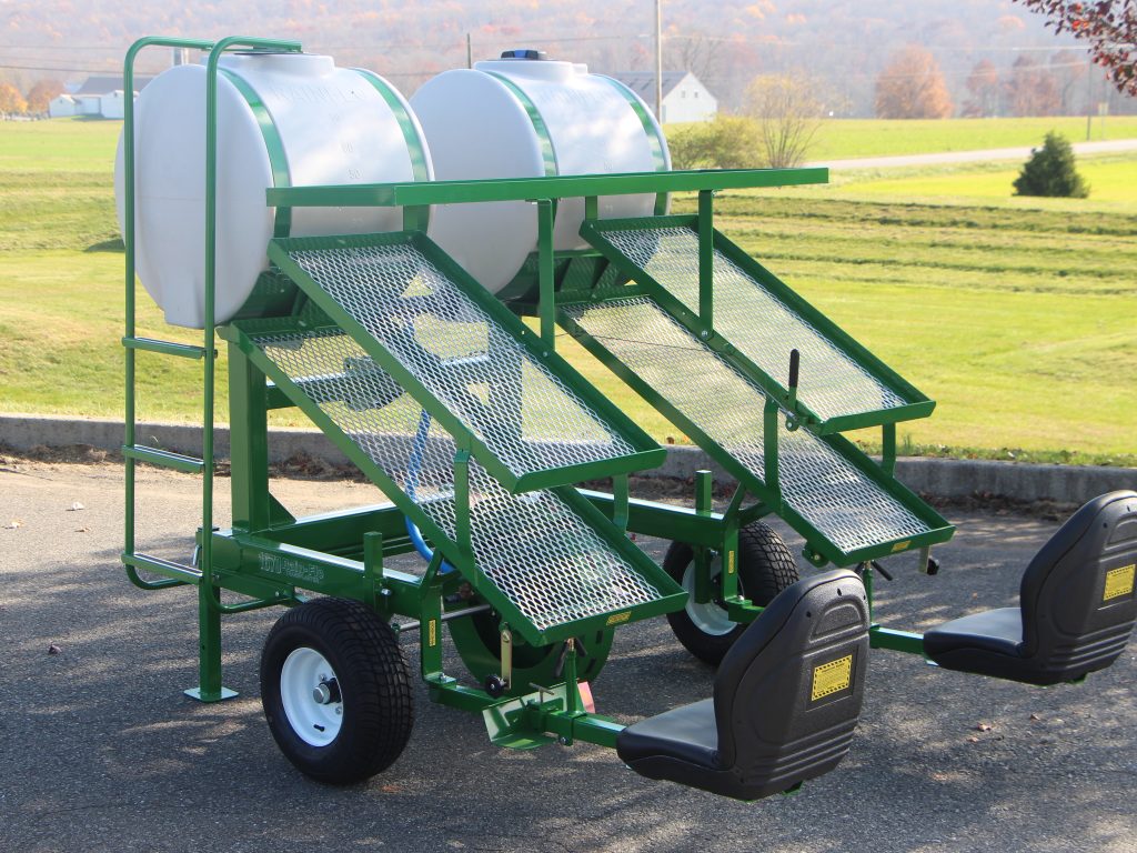 1670 Transplanter with double water tanks and planting wheels is a must on  the farm!