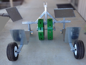 P1 Plug Transplanter with Wheels to make holes in plastic mulch film.  P1 made at Berryhill. P1 Plug Transplanter with Wheels to make holes in plastic mulch film.  P1 made at Berryhill.
